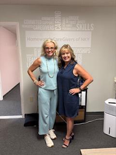 Two women smiling next to each other