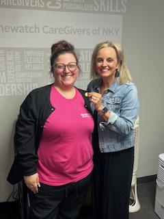 Two women smiling next to each other