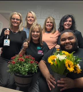 Two women smiling next to each other