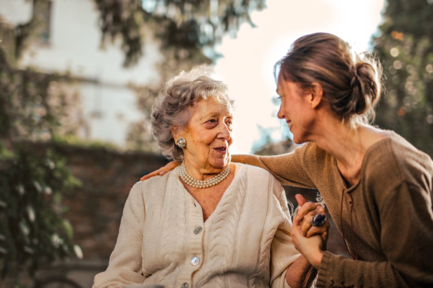 women sitting next to each other and smiling